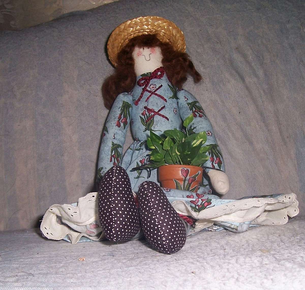 This sock type shelf-sitter doll is a wonderful cottage decoration!  She measures 20" tall by approximately 6" wide. Whomever created her was an artist, and a perfectionist at that-she has matching or coordinating   clothing and a beautifully-co