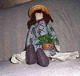 This sock type shelf-sitter doll is a wonderful cottage decoration!  She measures 20" tall by approximately 6" wide. Whomever created her was an artist, and a perfectionist at that-she has matching or coordinating   clothing and a beautifully-co