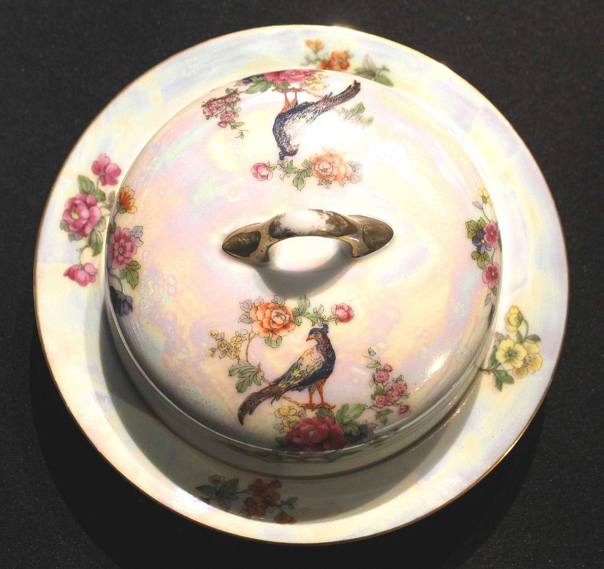 Up for sale is this Rare Vintage Beautiful Czechoslovakia CZE102 Iridescent Butter Dish with lid and insert with a Bird Design. The Butter dish measures approx. 7 3/4"W without the lid.and about 1 3/8"T without the lid. There are no chips or cra