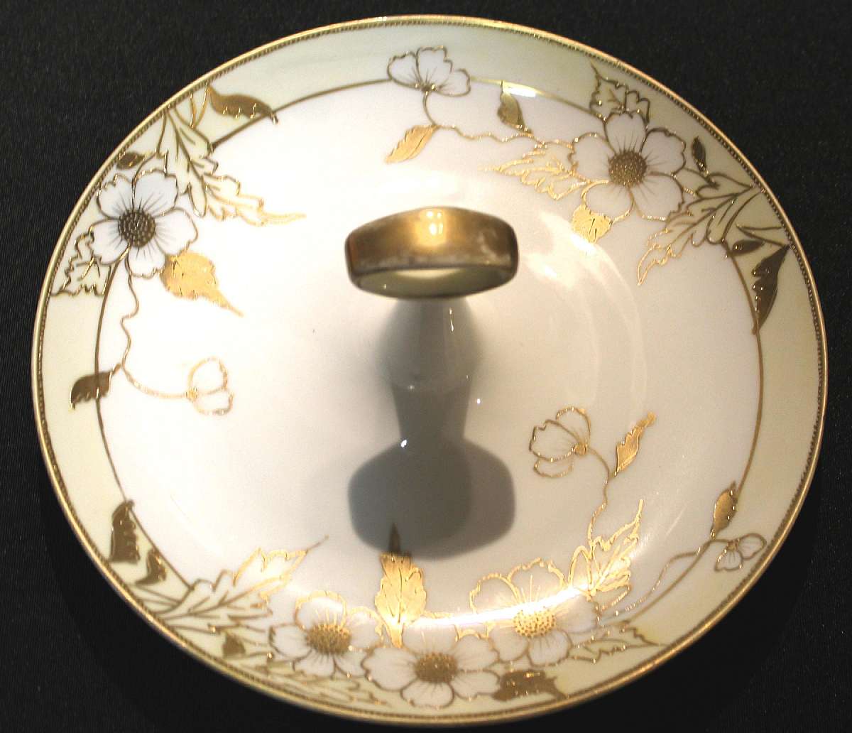 Up for sale is this Nippon Hand Painted Gold Leaf Floral Design Handled Plate in very good condition. Measures approx. 8"W. Has some gold wear & a manufactures defect. Shipping Excludes: Alaska/Hawaii, US Protectorates, APO/FPO, PO Box Shipping