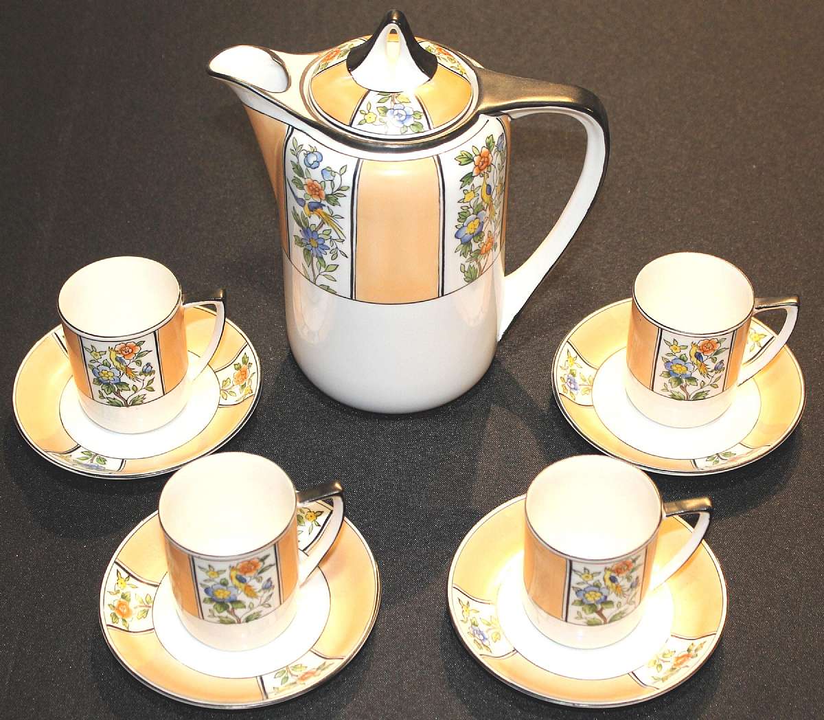 Up for sale is this Noritake Japan Coffee Or Chocolate Pot With 4 Demitasse Cup & Saucer Sets in great condition. The pot measures 7"T to the spout. The 4 cups measure approx. 2 3/4" and 2 1/4"W. The 4 saucers are 4 3/4"W.  Nice Vi