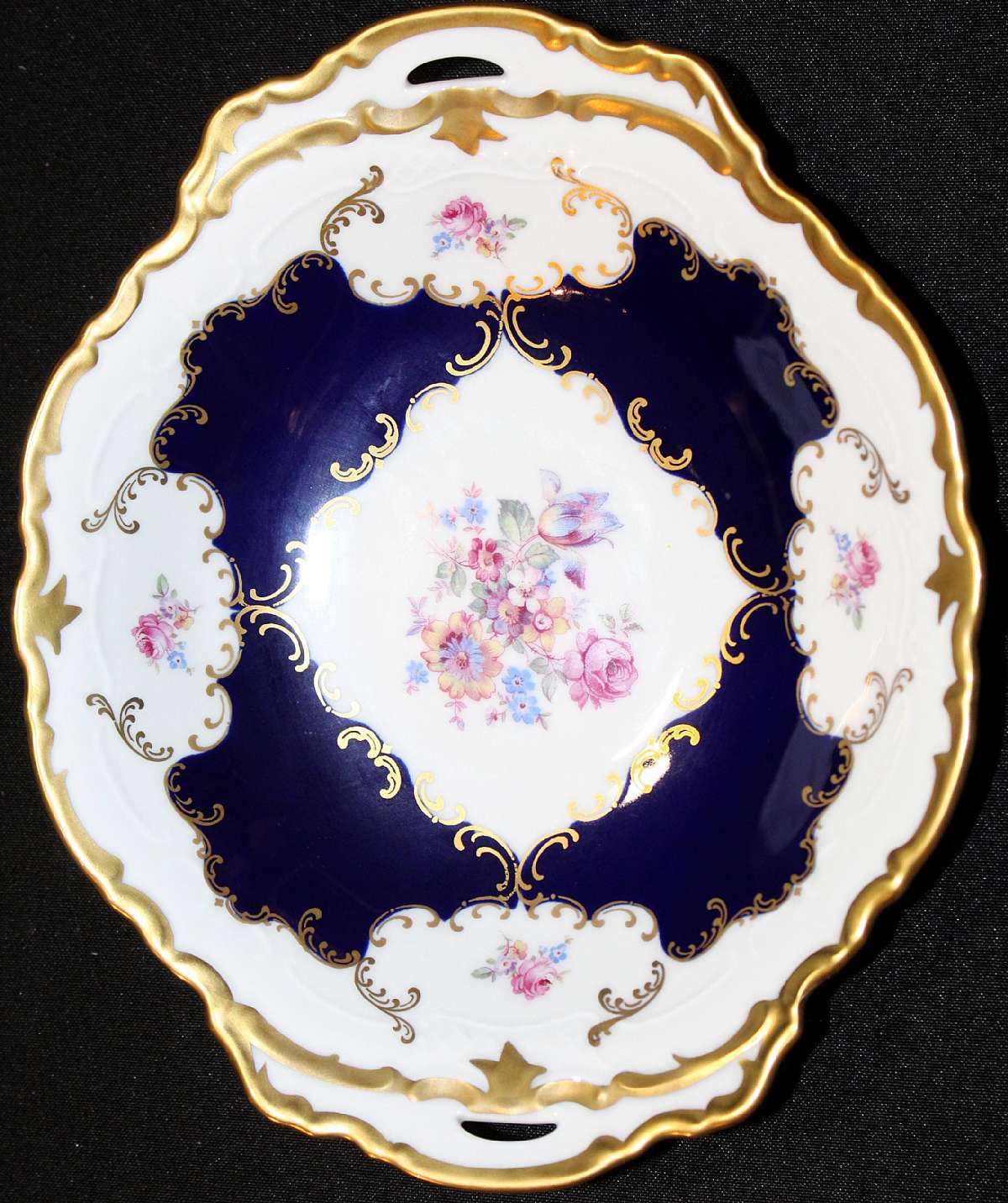 Up for sale is this beautiful Reichenbach Echt Kobalt Handled Bowl in excellent condition with no chips or cracks. Measures approx. 9 1/2" by 7 7/8" by 1 3/4" Deep.Shipping Excludes: Alaska/Hawaii, US Protectorates, APO/FPO, PO BoxShippin