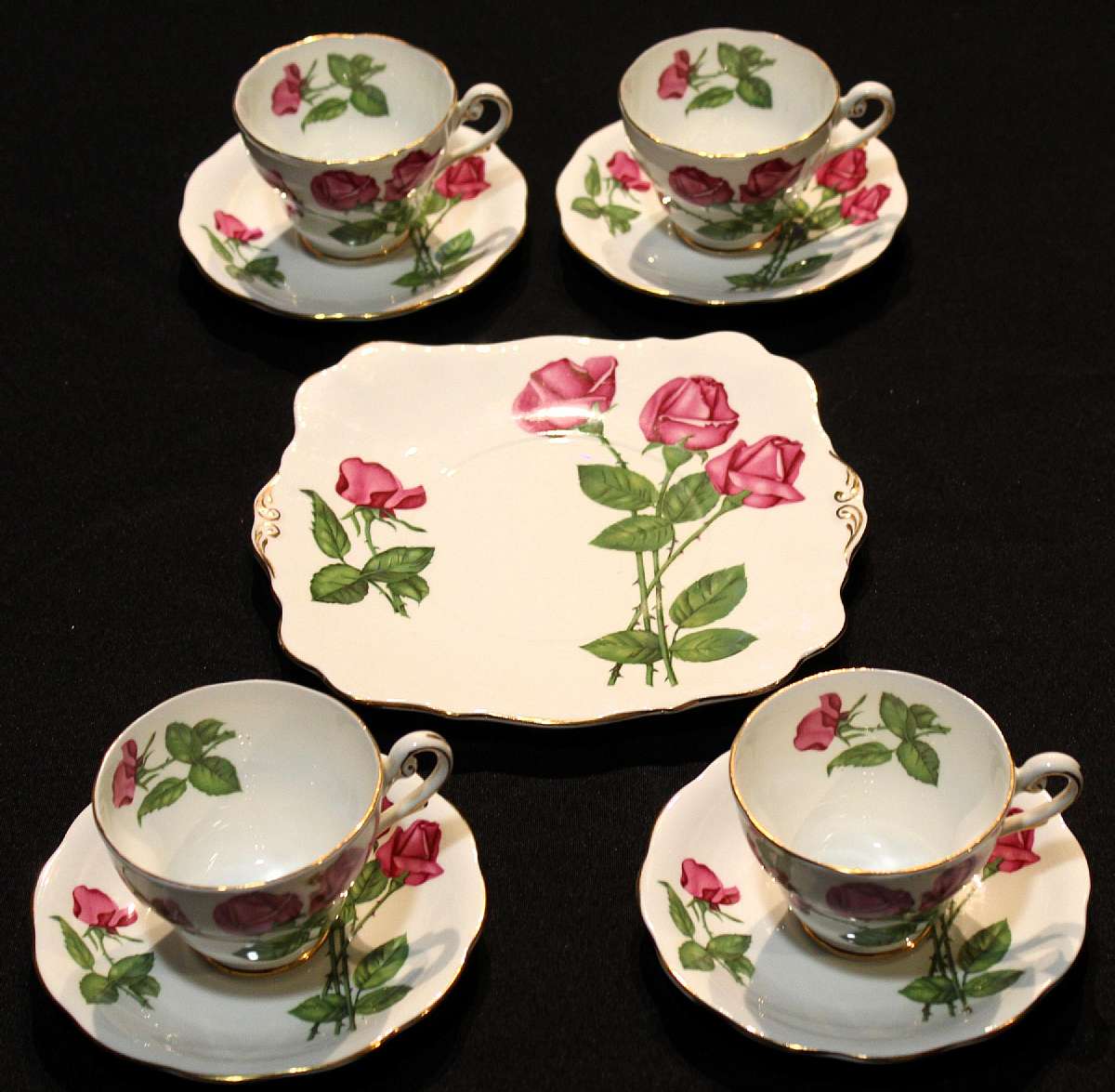 Up for sale are these Royal Standard Fine Bone China Three Red Roses Cake Plate & Four Cup and Saucer Sets in excellent condition with no chips or cracks. The Cups measure approx. 2 5/8"T by 3 1/2"W, the saucers 5 3/4"W. The cake plate