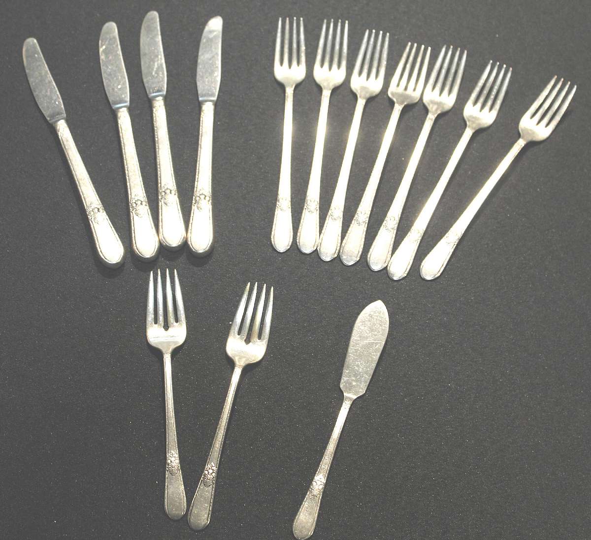 Up for sale are these 1847 Rogers Bros International Silver Adoration Fourteen Piece Set. Included are Four 8 1/2" Knifes, Two 6 3/4" Salad Forks, Seven 7 3/4" Forks and One 6 3/4" Butter knife. Everything we offer at auctions is pre - owned &/or used. Th
