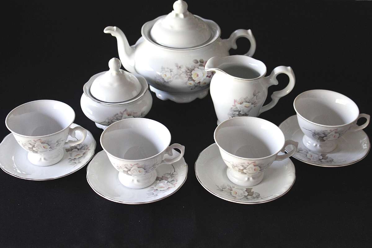 Up for sale is this Schmidt Porcelain White Rose Covered 4 1/2"T Tea Pot, one 4 1/4"T Creamer, one 2 1/2"T Covered Sugar Bowl & Four 2 5/8"T by 3 3/4"W Cups & Four 5 5/8" Saucers in excellent condition with no chips or cracks. The silver rim probably plat