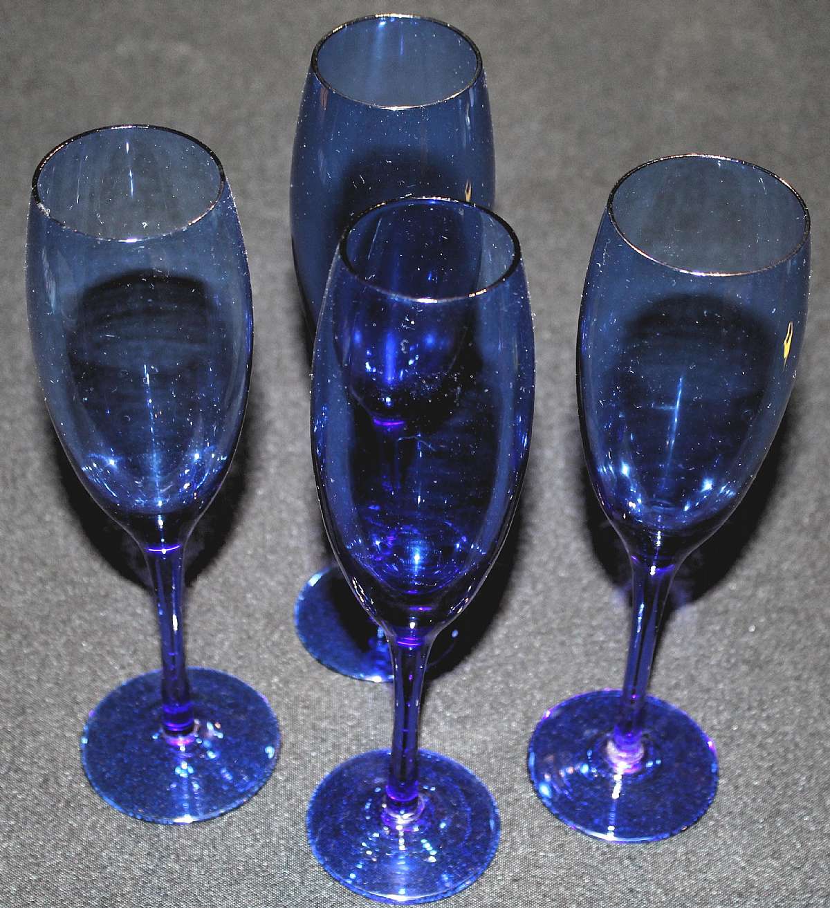 Up for sale are these Cobalt Blue Set Of Four Champagne Flutes in excellent condition with no chips or cracks. They measure approx. 9"T by 2"W. Shipping Excludes: Alaska/Hawaii, US Protectorates, APO/FPO, PO BoxShipping Provided to the United