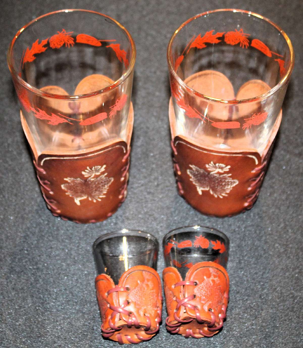 Up for sale are these Rare Vintage Libbey Glass Floral Plant Decals Four Leather Holders and Two Tall Highball Glasses & One Shot Glass in great condition with no chips or cracks. Some minor scratching from use. The Tall Glasses measure approx. 5 3/4"T by
