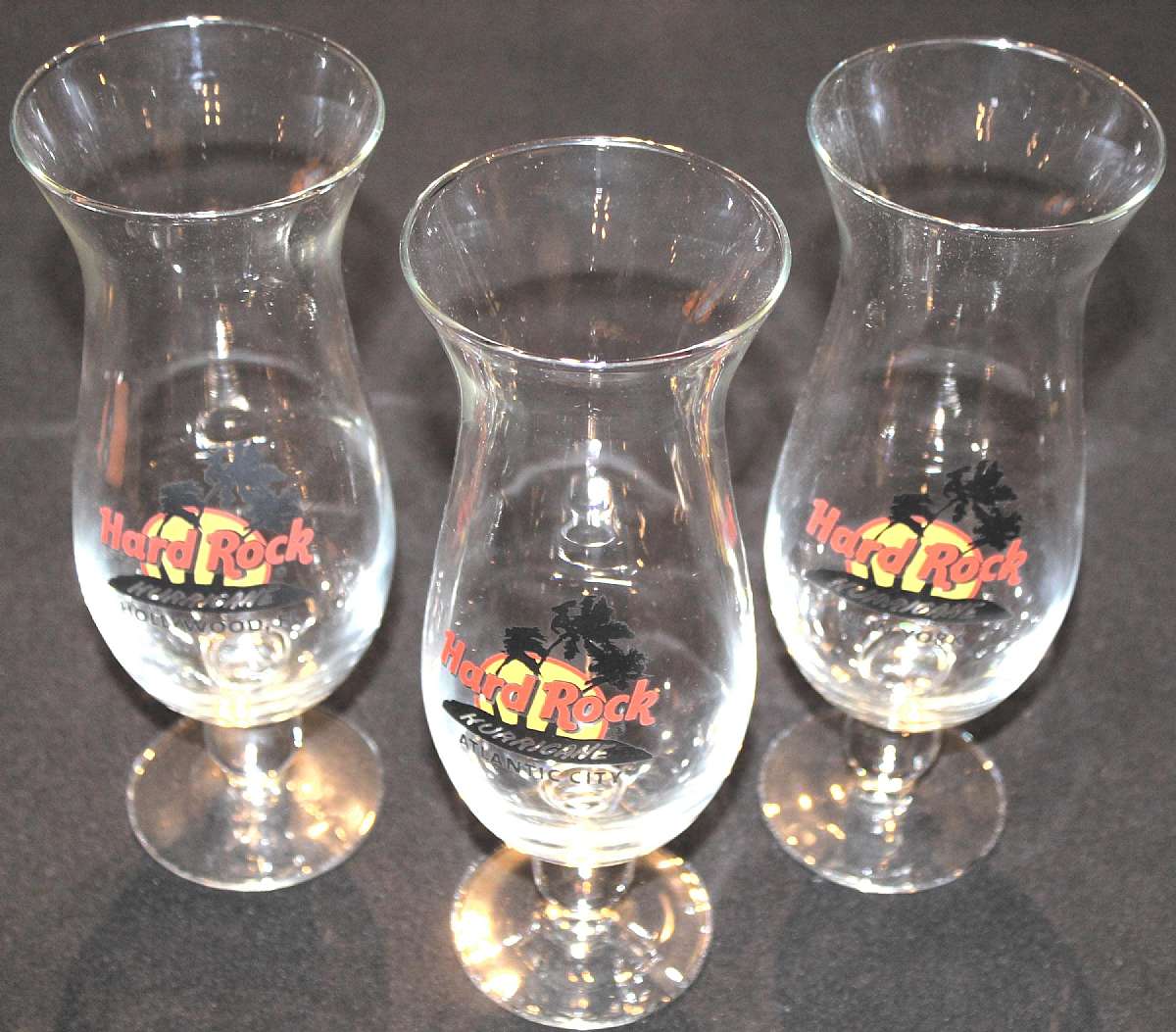 Up for sale are these Hard Rock Set Of Three Hurricane Glasses Hollywood FL - New York - Atlantic City in excellent condition with no chips or cracks. They measure approx. 9 1/4"T.Shipping Excludes: Alaska/Hawaii, US Protectorates, APO/FPO, PO BoxS