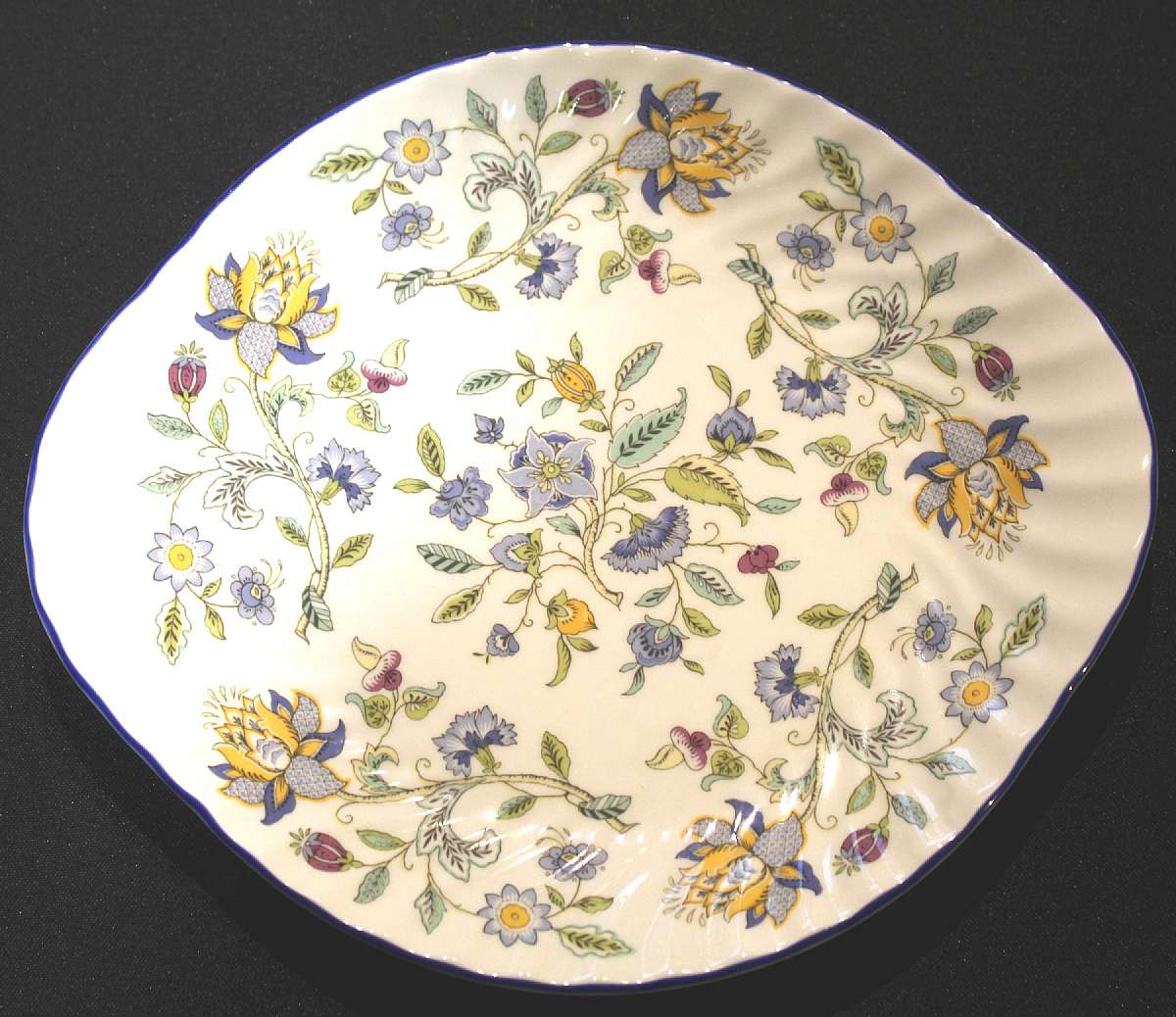 Up for sale is this Minton Haddon Hall Blue Bone China Handled Cake Plate in excellent condition with no chips or cracks. It measures approx. 10 3/4 inches wide.Shipping Excludes: Alaska/Hawaii, US Protectorates, APO/FPO, PO BoxShipping Provided to the