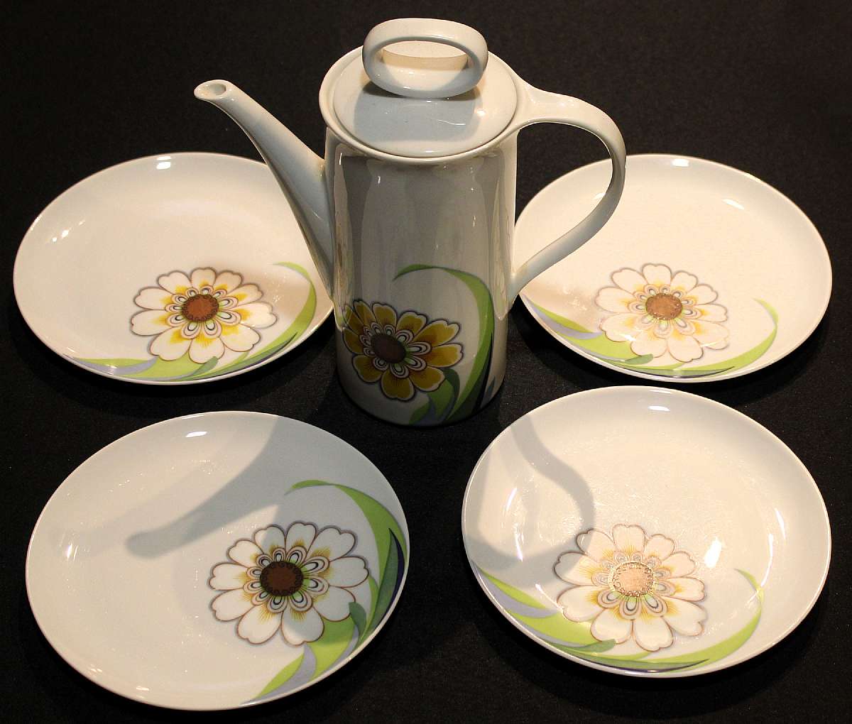 Up for sale is this vintage Eschenbach Bavaria Germany Coffee Pot & Four Plates in excellent condition with no chips or cracks. The coffee pot Measures approx. 7 5/8" Tall not measuring the lid and about 3 5/8"W measuring the base and the pl