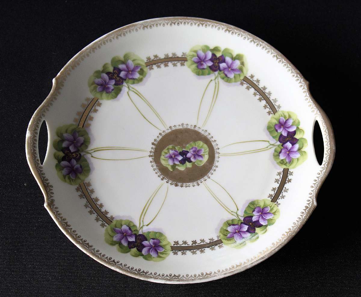 Up for sale is this antique Bavarian China Beautiful Handled Plate in great condition with no chips or cracks and minor gold wear. Measures approx. 10 1/4"W.Shipping Excludes: Alaska/Hawaii, US Protectorates, APO/FPO, PO BoxShipping Provided to the