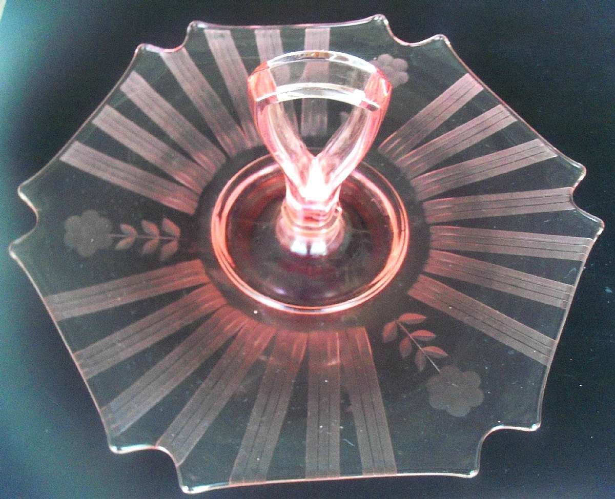 Up for sale is this Depression Glass Pink Handled Sandwich Plate in excellent condition with no chips or cracks. It measures approx. 5 inches tall Measuring the handle & about 11 inches wide at its widest point.  Shipping Excludes: Alaska/Hawaii, US