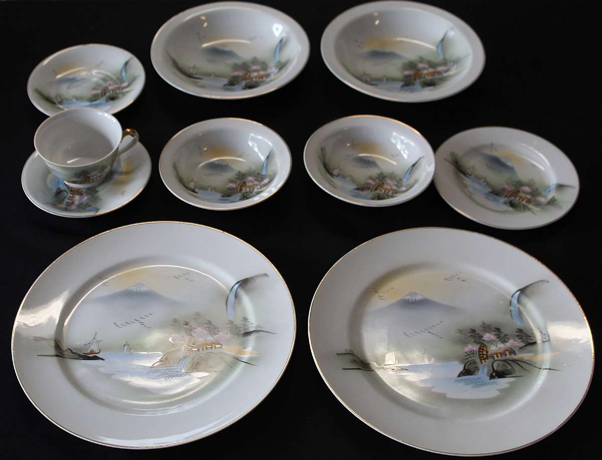 Up for sale is this Hand Painted Kutani 10 Piece Dinnerware depicting a waterfall & water wheel, mountain, ships, birds & houses. Included are two 5 1/2" Saucers, one 2 1/4"T by 3 5/8"W Cup, two 5 5/8"W Fruit Bowls, two 7 1/2"W Soup Bowls, one 6 5/8"W Bre