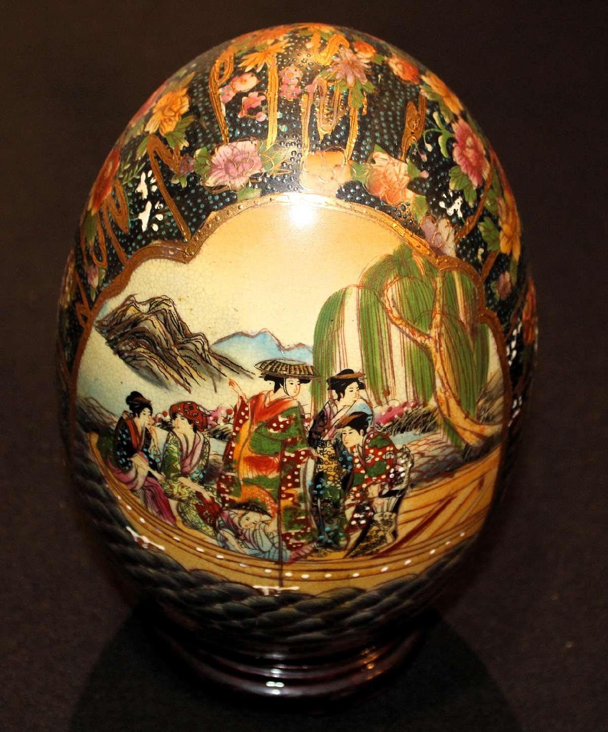 Up for sale is this Chinese Satsuma Egg With Stand Vintage Highly Decorated in Great Condition with no chips or cracks. It measures approx. 9"T . Highly decorated Item with enamel and gold. Comes with the wood stand.Shipping Excludes: Alaska/Hawaii,