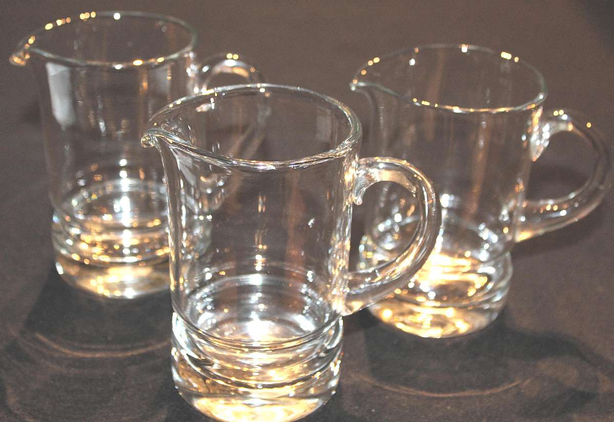 Up for sale are these Svend Jensen Set Of Three Pitchers - Jugs - Creamers in excellent condition with no chips or cracks. The Pitchers measure approx. 4 3/4"T by 3"W and hold approx. 12 ounces. They have stickers on the bottom that read Handcra