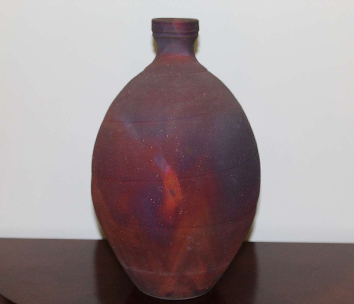 Up for sale is this McKee Pottery Wood Fired Raku Vase in great condition with no chips or cracks. Has a gritty surface to it like sand paper. The item measures approx. 13 1/2"T. Signed McKee on the reverse. The first two pictures were taken without using