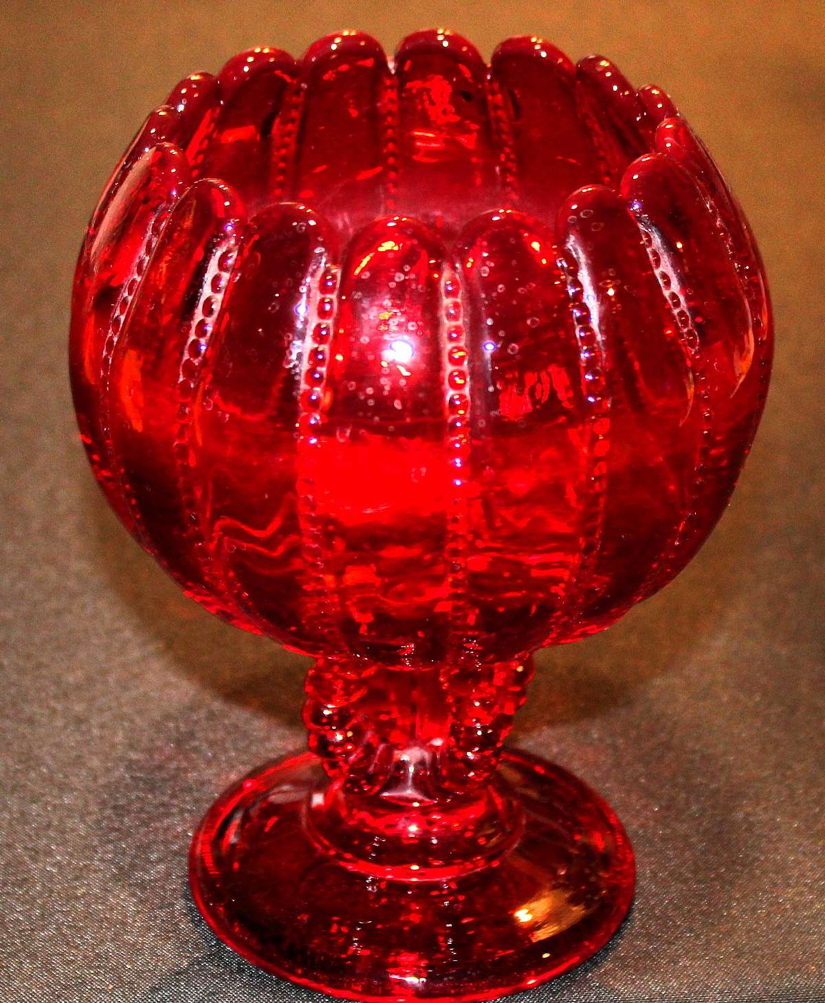 Up for sale is this Wright Glass Beaded Red Ruby Compote in good condition with no chips or cracks. Beautiful item that measures approx. 7 1/4"T by about 4 1/4"W. Looks like it was used as a flower vase at one time because of a hard water line.