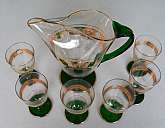 Up for sale is this Gorgeous Green and Gold Vintage Glass Pitcher & 6 Glasses. Included are Six 8 ounce glasses that measure approx. 5"T and one 48 ounce pitcher that measures approx. 9 1/2"T  These are in excellent condition with no chips o