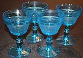 Up for sale are these Four Colony Blue Sandwich Pattern Champagne or Sherbet Glasses in excellent condition with no chips or cracks. The glasses measure approx. 5 3/8"T by 3 1/2"W.  Shipping Excludes: Alaska/Hawaii, US Protectorates, APO/FPO,
