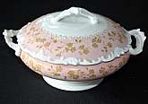 Up for sale is this antique T & V France ( Tressemanes & Vogt) Pink & Gold Floral Covered Casserole in great condition with no chips or cracks and minor gold wear. Measures approx. 8"W without the lid and is about 3 1/8"D. Shipping